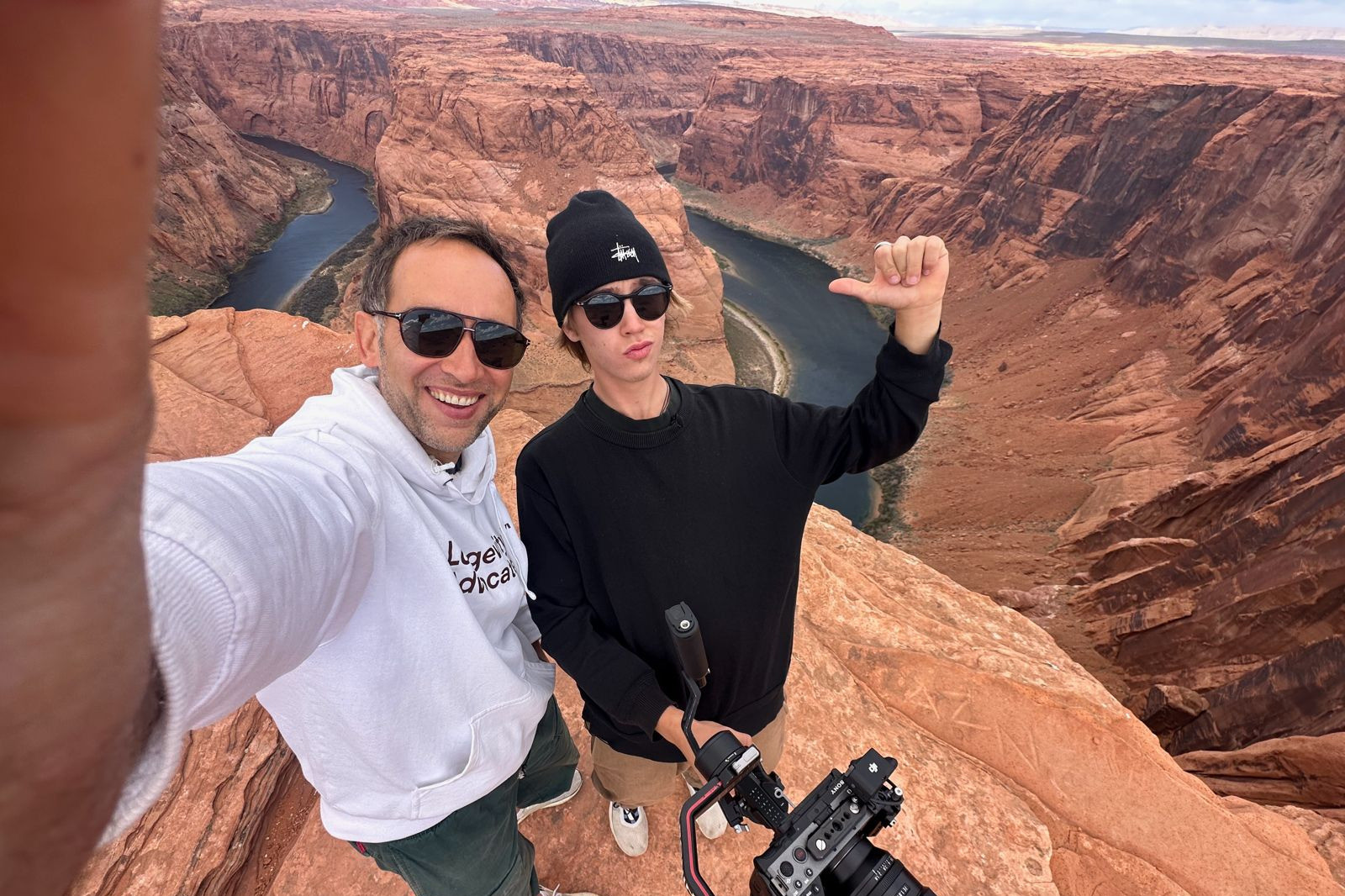 Marek and Alek on the rim at Horseshoe Bend, Arizona, with the camera