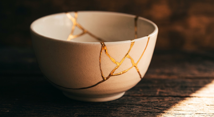 A broken bowl mended in gold rather than thrown away. Damage happens every day; what matters is the mending.