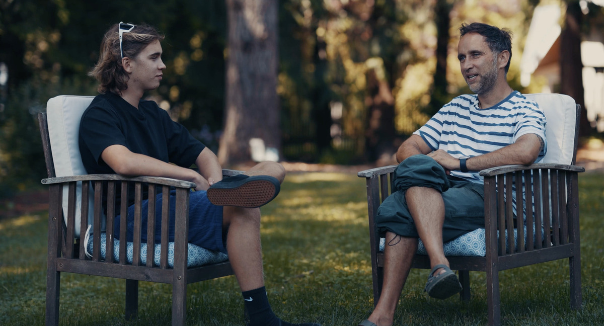 Marek and Alek talking in a garden in Seattle, June 2024.