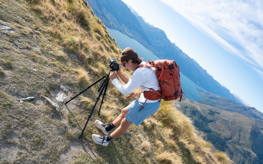 Alek setting up on a mountain peak, New Zealand