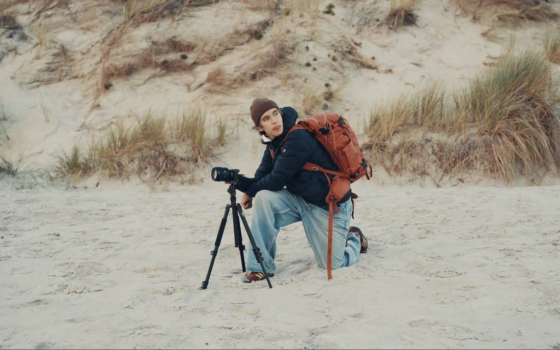 Alek on a beach in New Zealand, learning it as we went